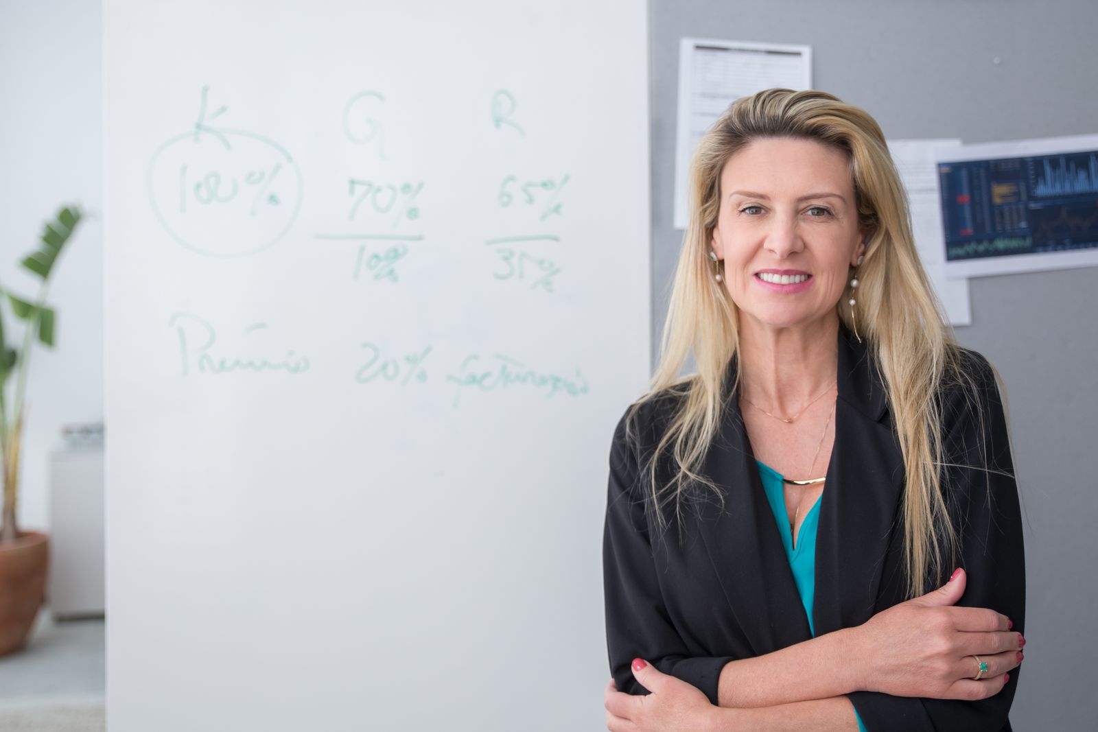 Stock photograph of a professional woman standing beside a whiteboard