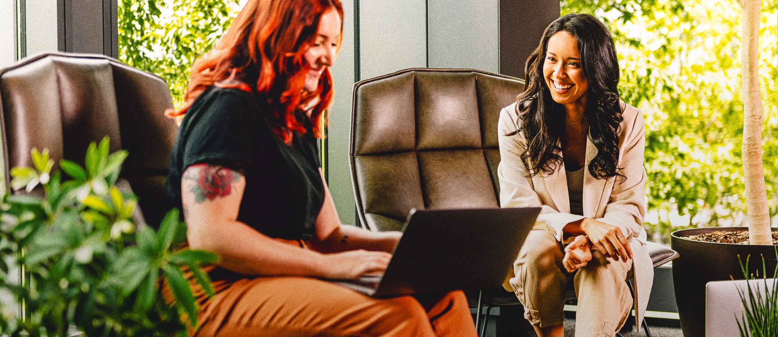 Two colleagues in conversation in a Tripadvisor workplace